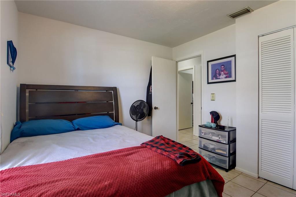 4209 Skyline Boulevard, Unit 4209 Cape Coral, FL 33914 - Photo 11 of 23 a bedroom with a bed and a closet