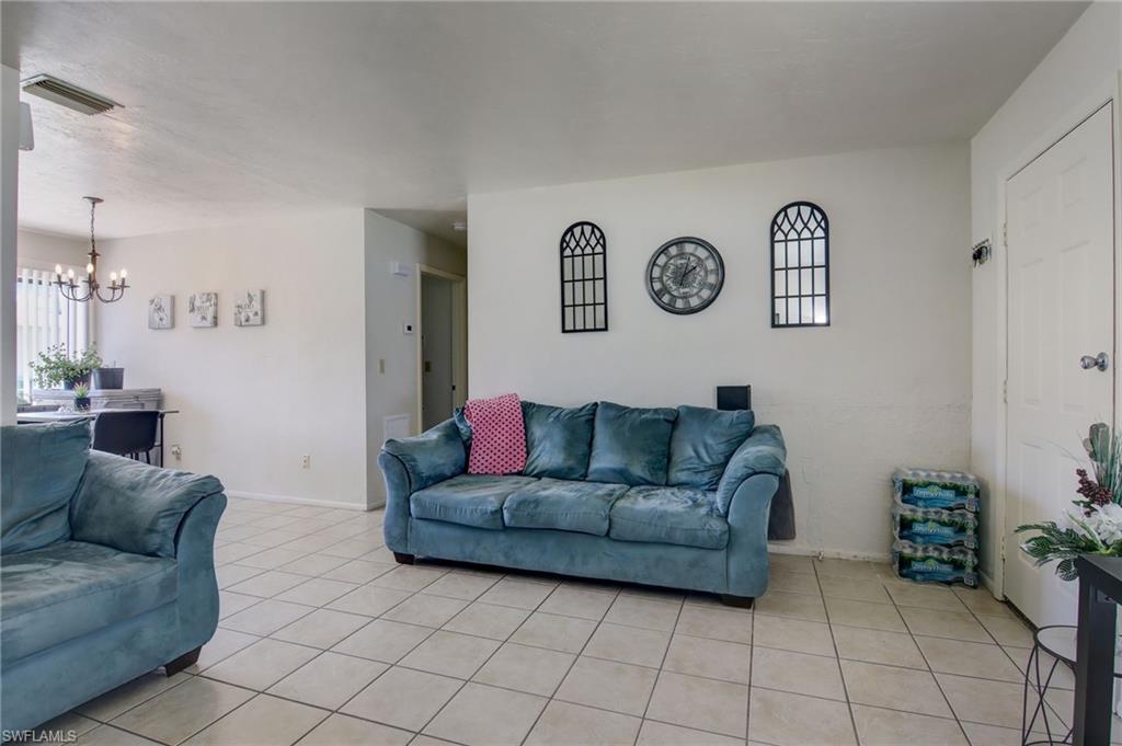 4209 Skyline Boulevard, Unit 4209 Cape Coral, FL 33914 - Photo 16 of 23 a living room with furniture and a table