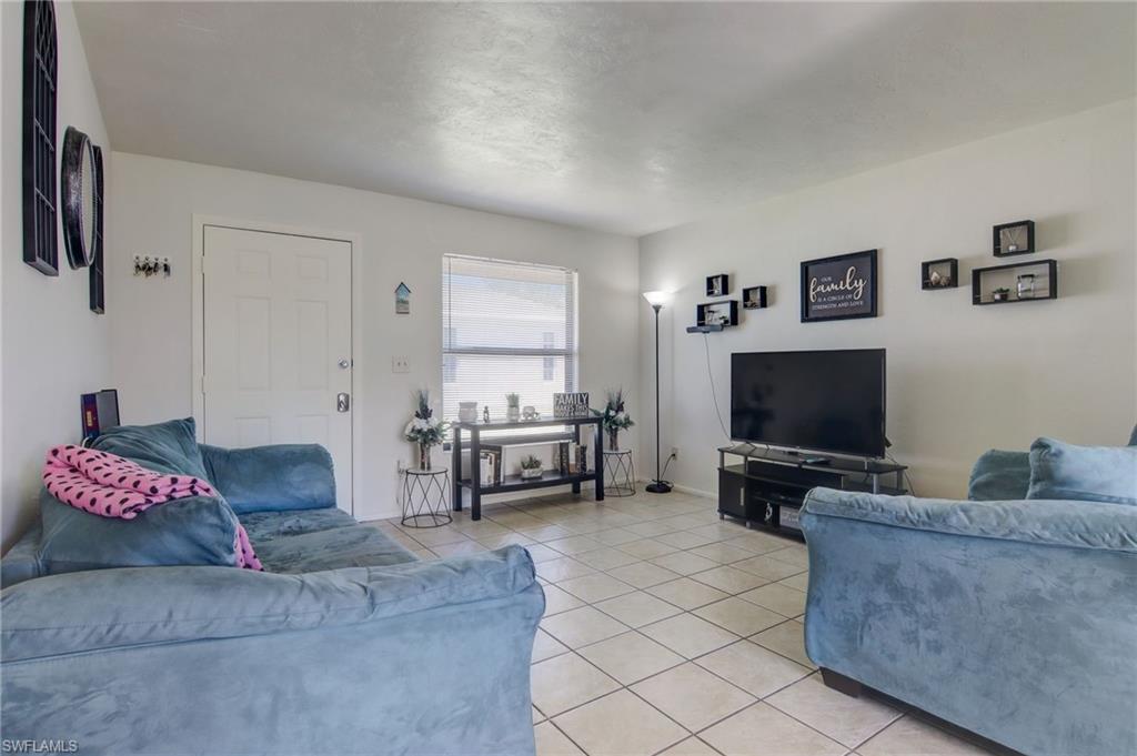 4209 Skyline Boulevard, Unit 4209 Cape Coral, FL 33914 - Photo 17 of 23 a living room with furniture and a flat screen tv