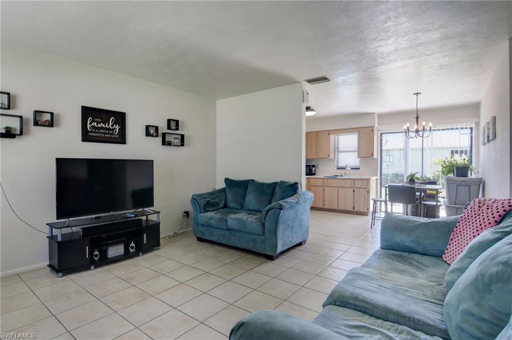 4209 Skyline Boulevard, Unit 4209 Cape Coral, FL 33914 - Photo 20 of 23 a living room with furniture and a flat screen tv