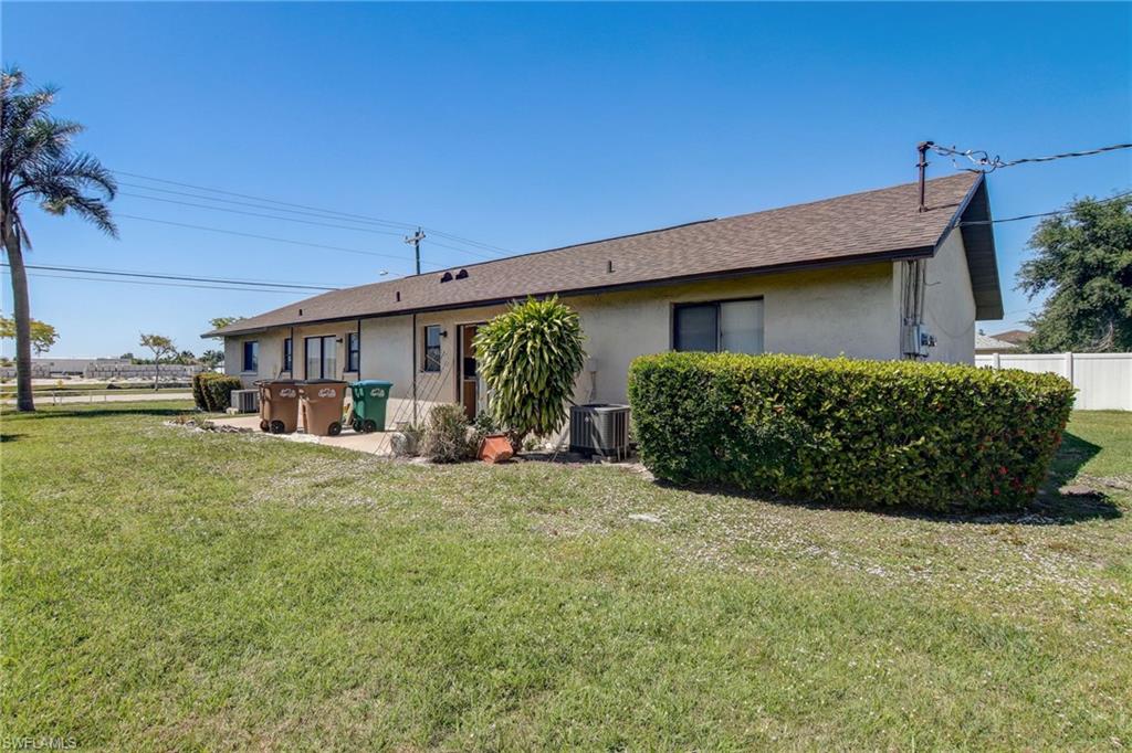 4209 Skyline Boulevard, Unit 4209 Cape Coral, FL 33914 - Photo 2 of 23 a front view of a house with garden
