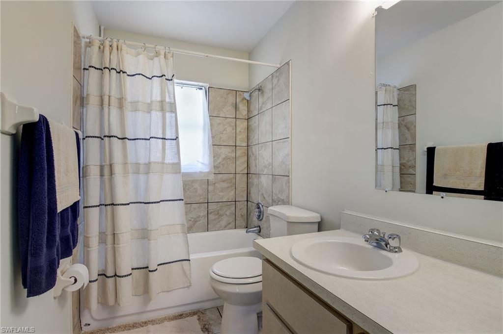 4209 Skyline Boulevard, Unit 4209 Cape Coral, FL 33914 - Photo 7 of 23 a bathroom with a sink a toilet and shower