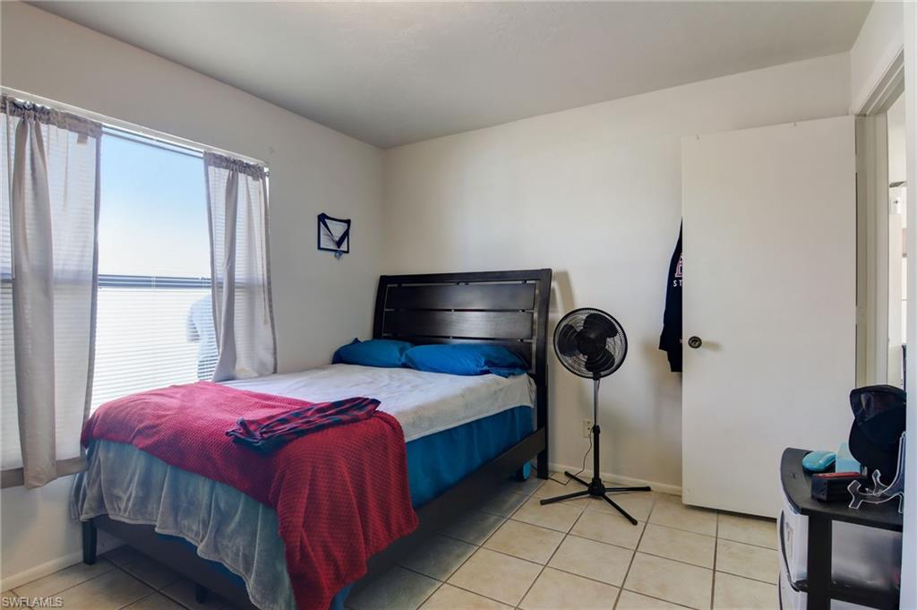 4209 Skyline Boulevard, Unit 4209 Cape Coral, FL 33914 - Photo 10 of 23 a bedroom with a bed and a window