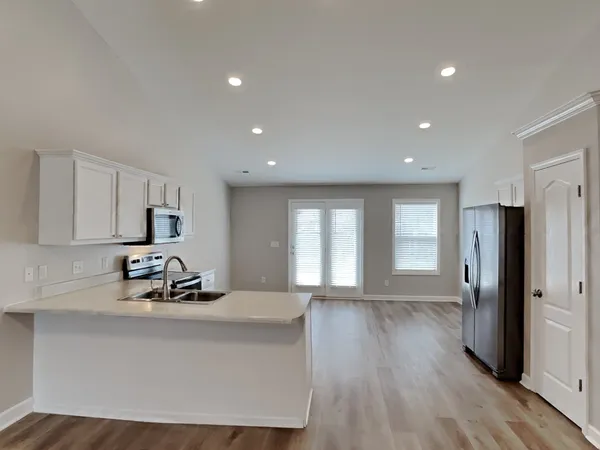 a room with wooden floor and large window