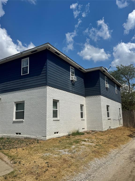 10914 Shiloh Road Dallas, TX 75228 - Photo 3 of 3 Two-story exterior featuring white painted brick and dark blue horizontal siding