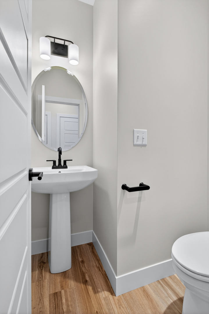 412 North 2nd Street Eldridge, IA 52748 - Photo 6 of 30 a bathroom with a sink toilet and shower