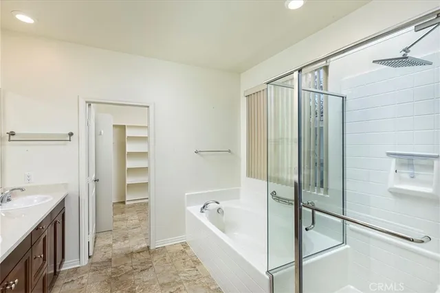 a bathroom with a tub a sink and a shower