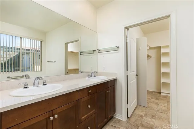 a bathroom with a sink double vanity and a mirror
