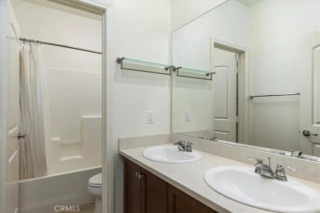 a bathroom with a sink toilet a shower and a mirror