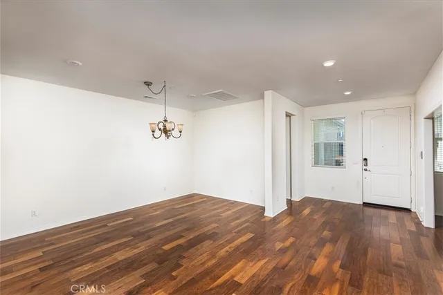 a view of a room with wooden floor