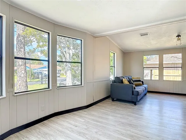 a living room with furniture and windows