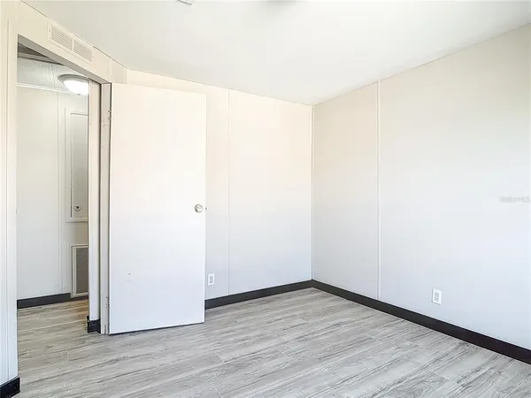 a view of a room with wooden floor
