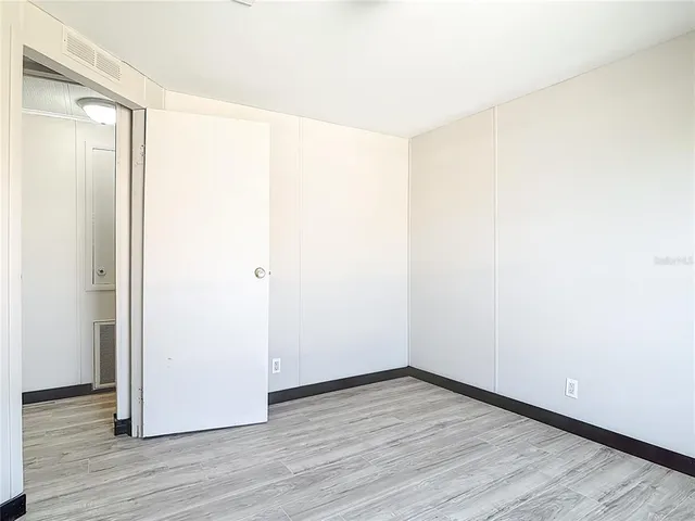 a view of a room with wooden floor