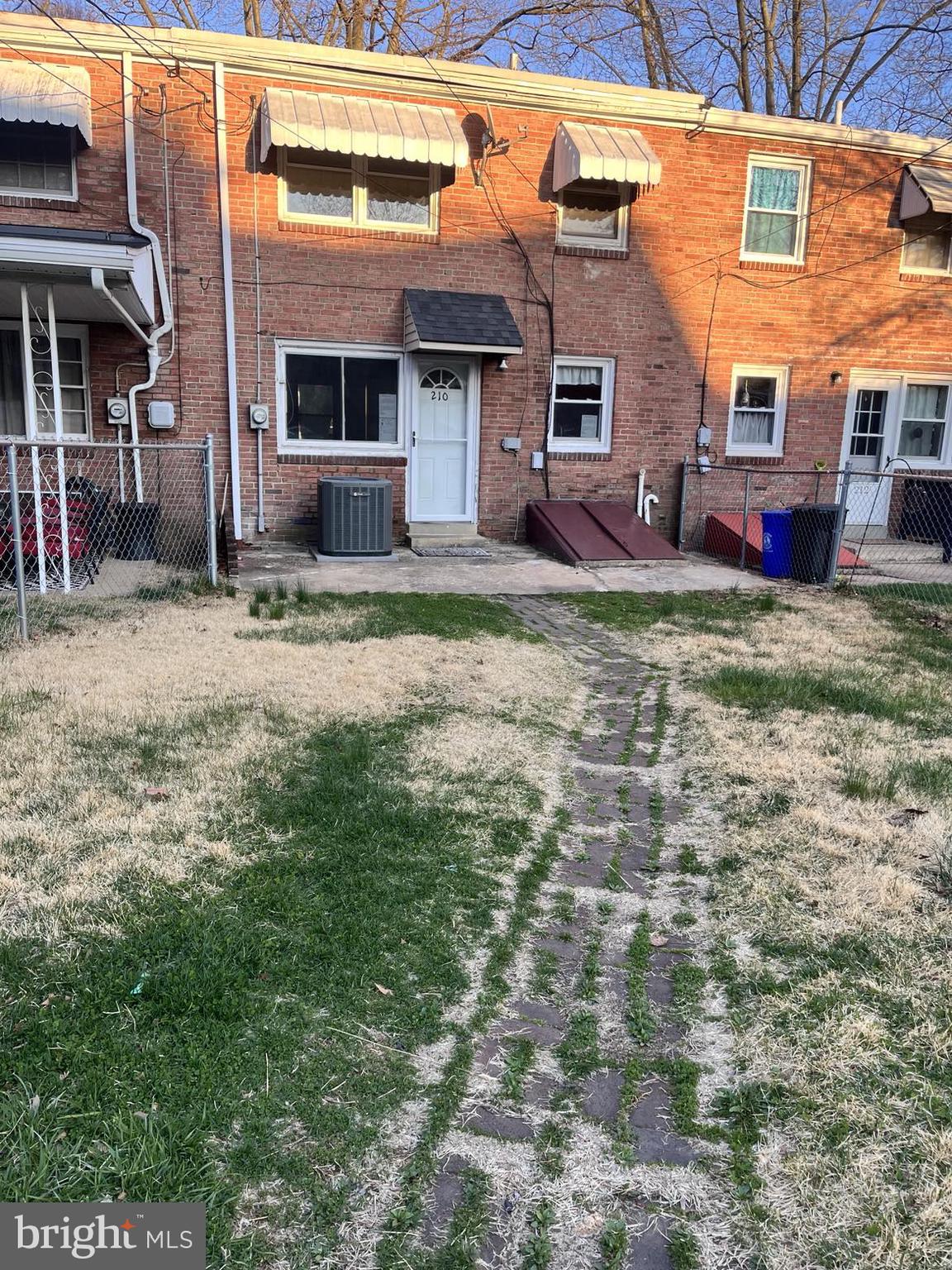 210 Sycamore Road Reading, PA 19611 - Photo 14 of 16 a view of a brick house with many windows next to a yard