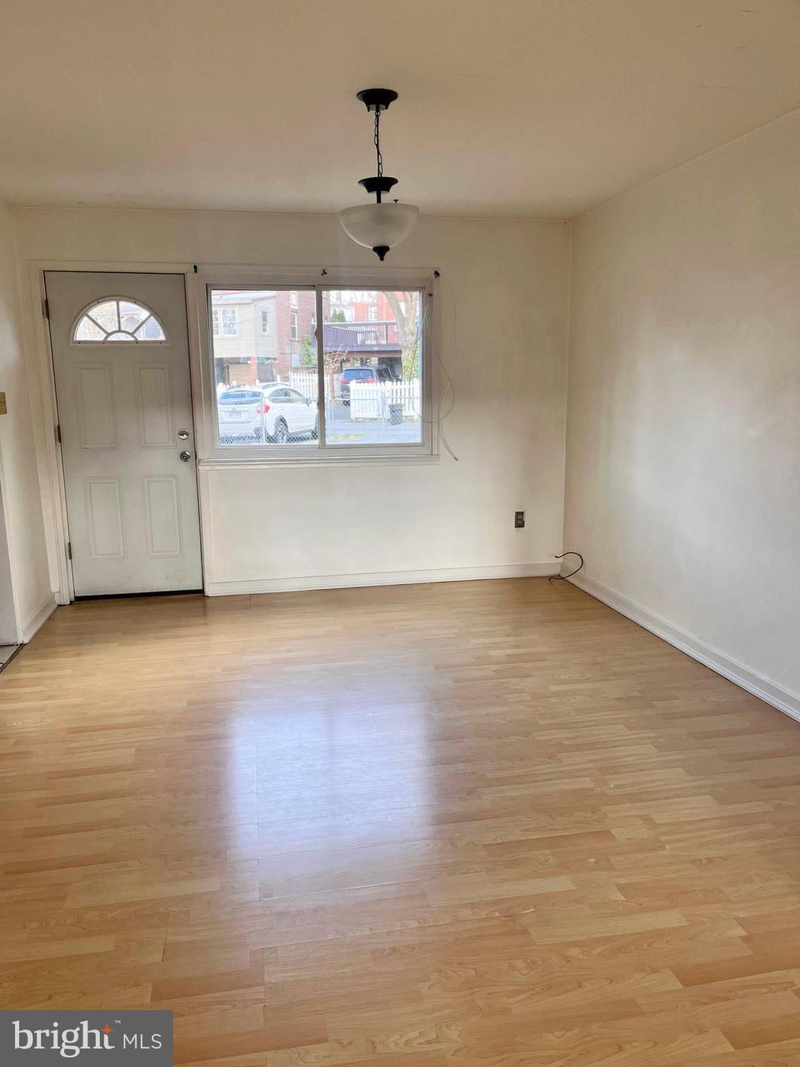 210 Sycamore Road Reading, PA 19611 - Photo 3 of 16 an empty room with wooden floor and windows