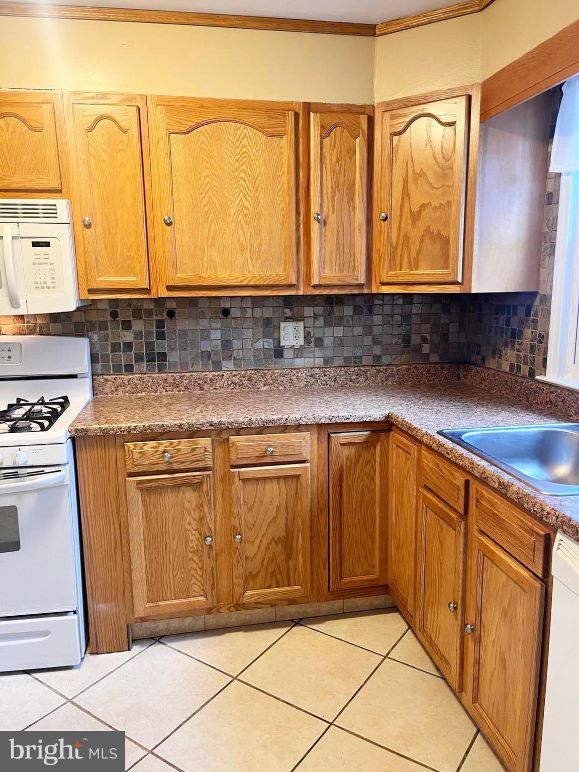 210 Sycamore Road Reading, PA 19611 - Photo 5 of 16 a kitchen with stainless steel appliances granite countertop a sink and cabinets
