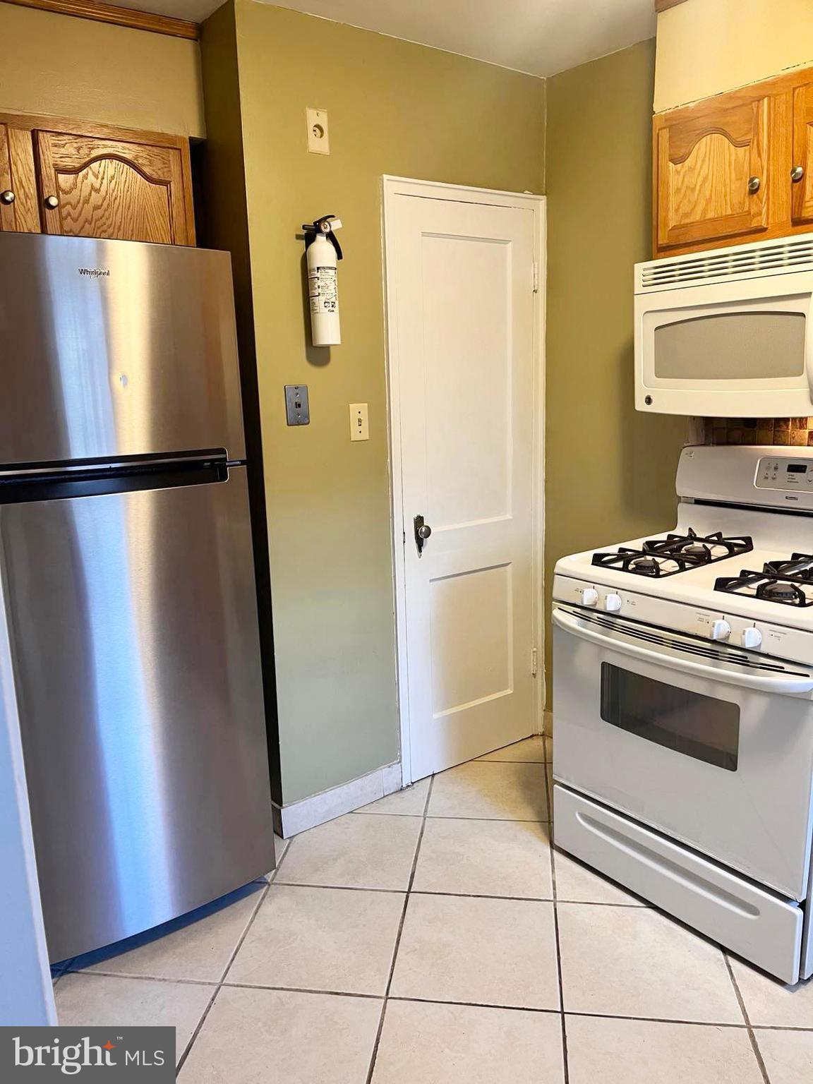 210 Sycamore Road Reading, PA 19611 - Photo 6 of 16 a white refrigerator freezer and a stove sitting inside of a kitchen