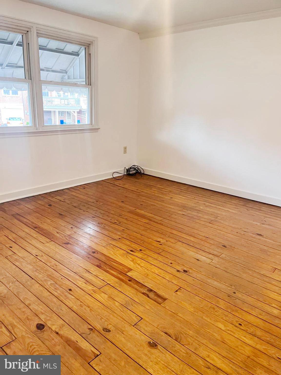 210 Sycamore Road Reading, PA 19611 - Photo 7 of 16 an empty room with wooden floor and windows