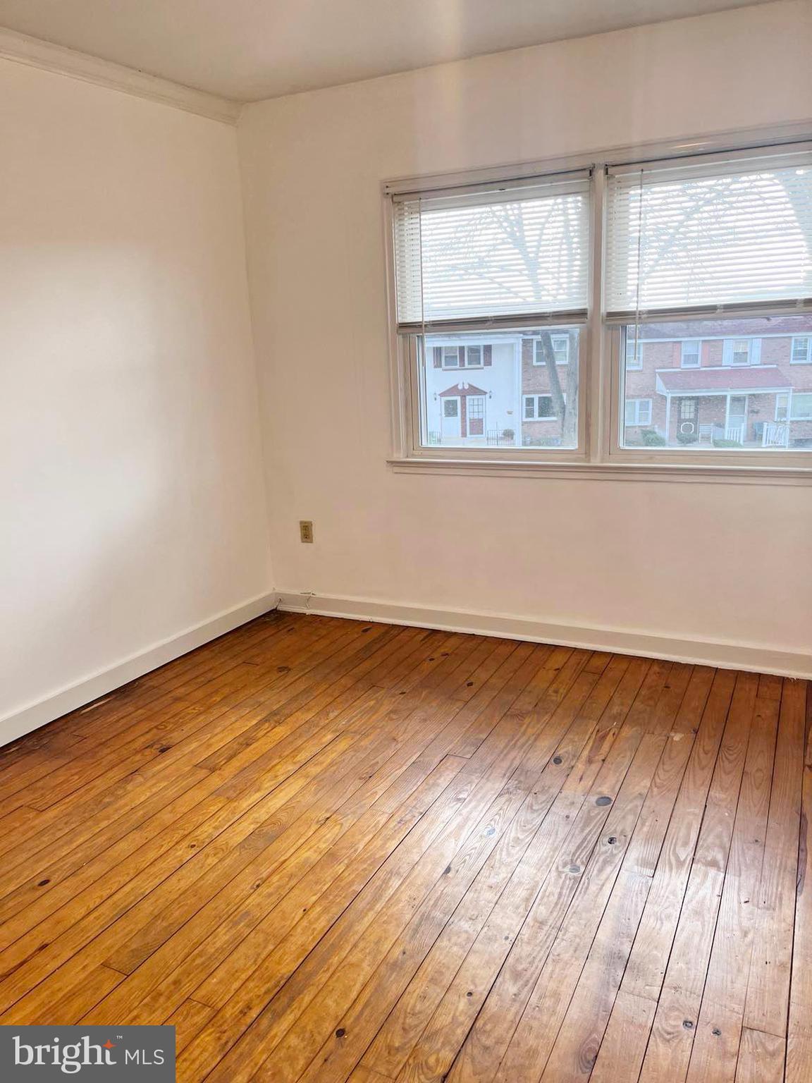 210 Sycamore Road Reading, PA 19611 - Photo 8 of 16 an empty room with wooden floor and windows