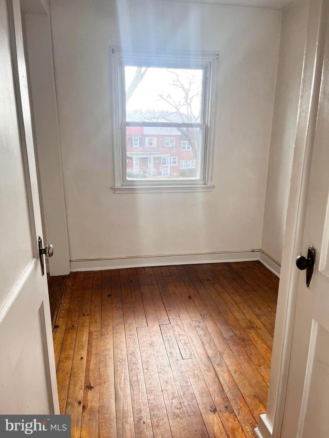 210 Sycamore Road Reading, PA 19611 - Photo 9 of 16 an empty room with wooden floor and windows