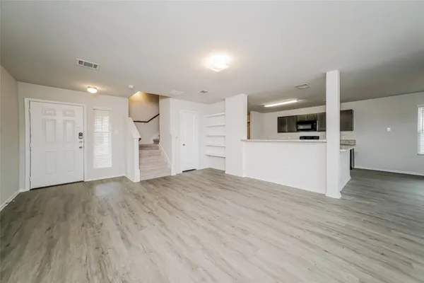 a view of a kitchen with a sink and a refrigerator