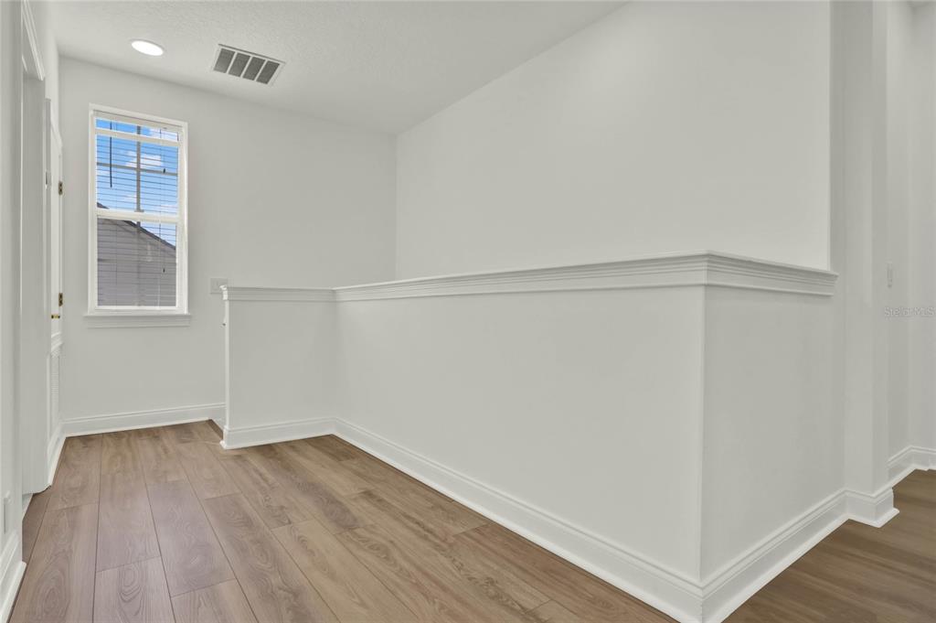 8418 Bowden Way Windermere, FL 34786 - Photo 14 of 31 a view of an empty room with wooden floor