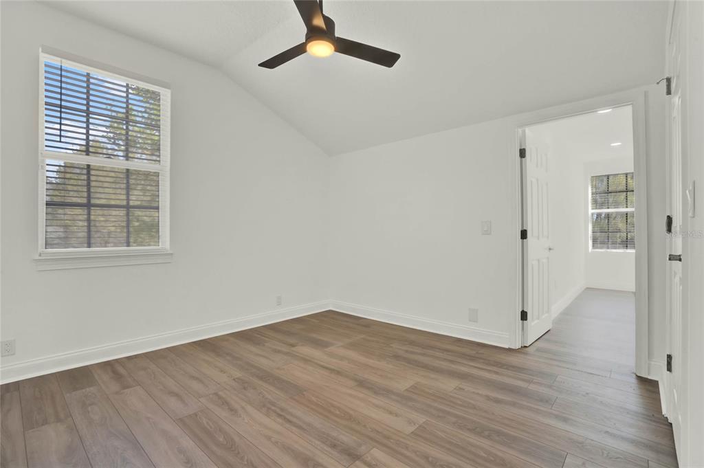 8418 Bowden Way Windermere, FL 34786 - Photo 15 of 31 an empty room with wooden floor cabinet and windows