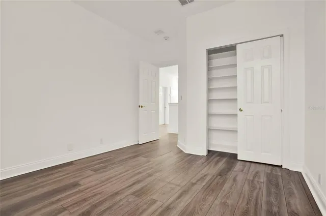 an empty room with wooden floor