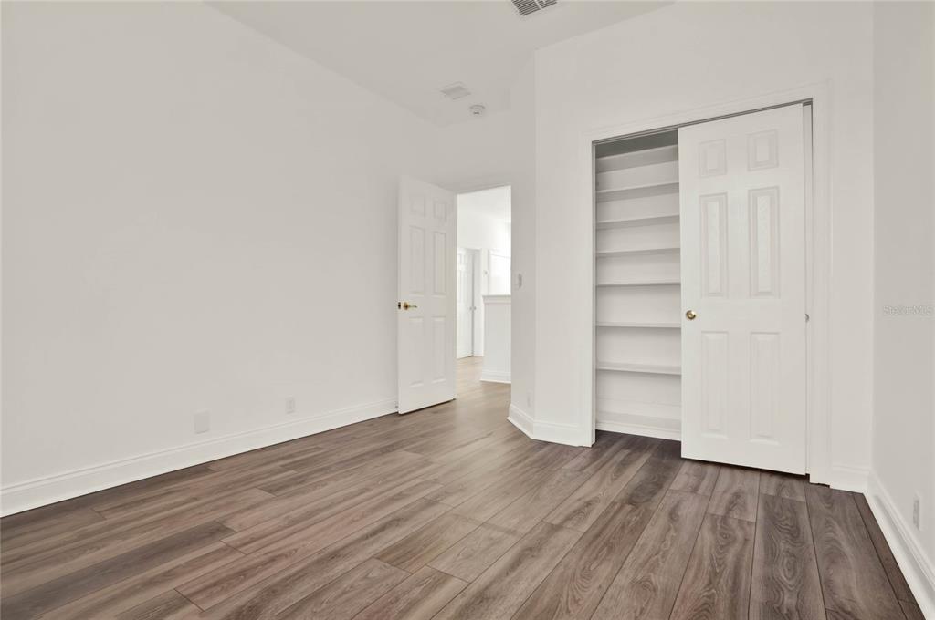 8418 Bowden Way Windermere, FL 34786 - Photo 18 of 31 an empty room with wooden floor