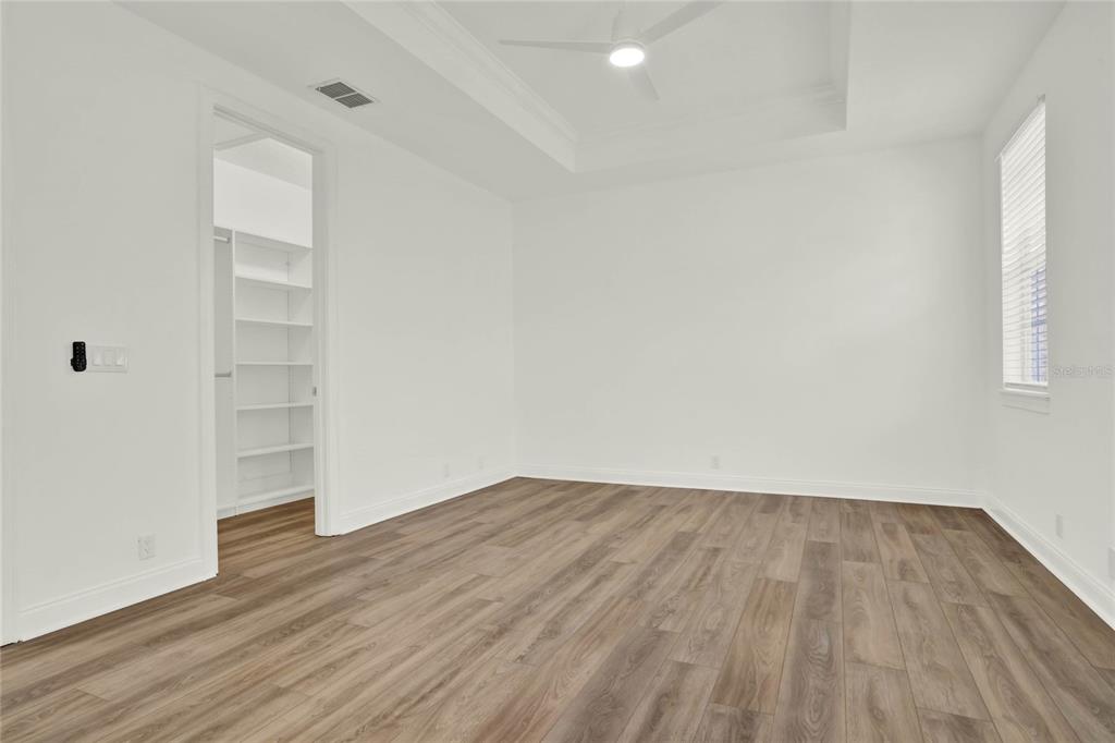 8418 Bowden Way Windermere, FL 34786 - Photo 20 of 31 an empty room with wooden floor and closet