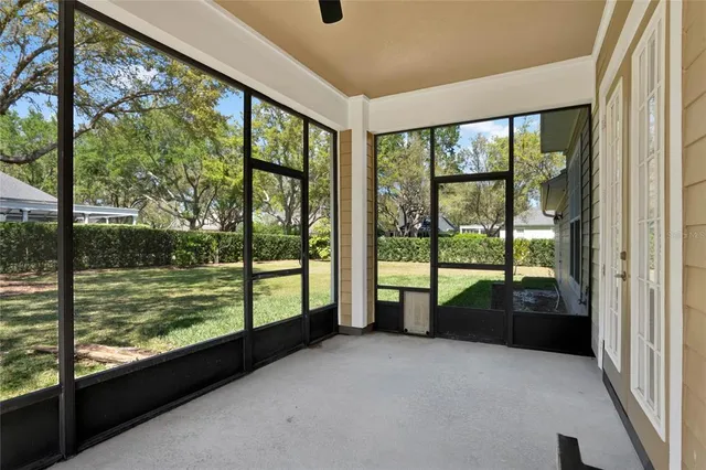 a view of a big room with wooden floor and floor to ceiling window