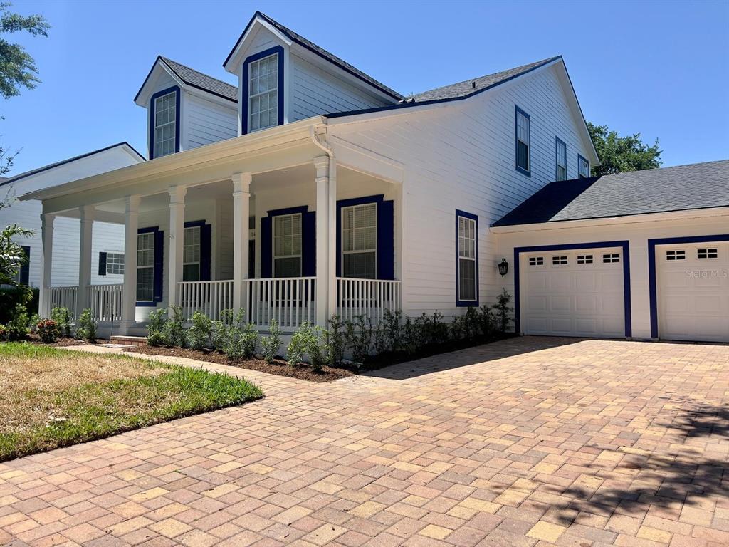 8418 Bowden Way Windermere, FL 34786 - Photo 28 of 31 a front view of a house with a yard and potted plants
