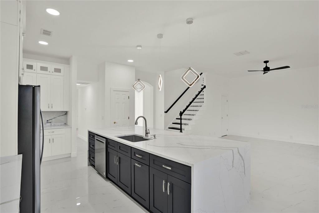 8418 Bowden Way Windermere, FL 34786 - Photo 3 of 31 a kitchen with stainless steel appliances a sink and a refrigerator