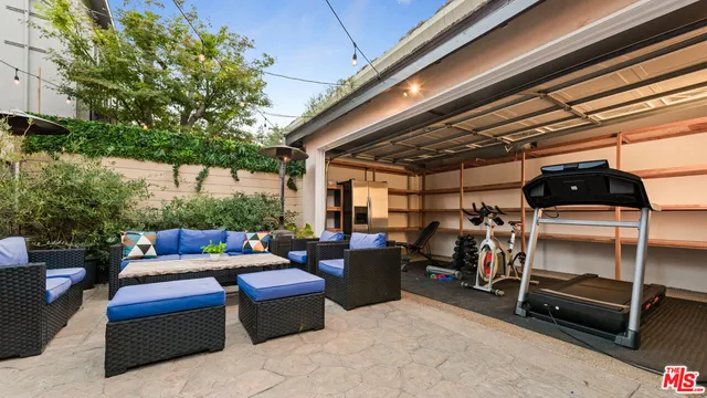 a view of a patio with table and chairs and potted plants