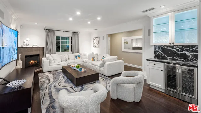 a living room with furniture a window and a fireplace