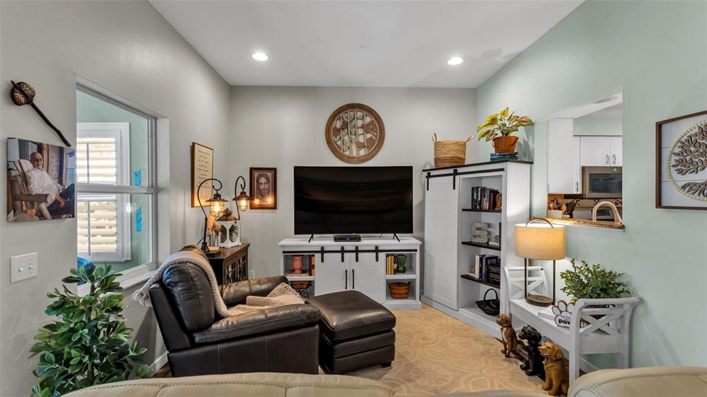 728 Canberra Road Winter Haven, FL 33884 - Photo 18 of 47 a living room with furniture and a flat screen tv
