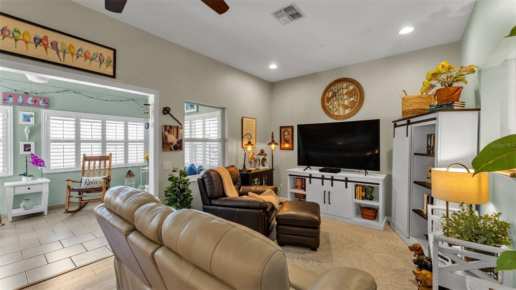 728 Canberra Road Winter Haven, FL 33884 - Photo 20 of 47 a living room with furniture and a flat screen tv