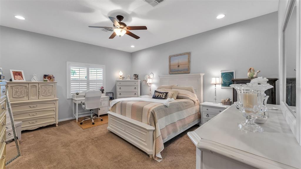 728 Canberra Road Winter Haven, FL 33884 - Photo 24 of 47 a bedroom with bed and a chandelier