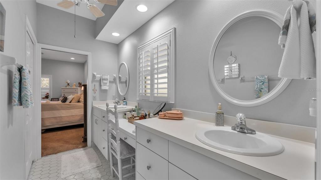 728 Canberra Road Winter Haven, FL 33884 - Photo 27 of 47 a en suite bathroom with a double vanity sink a mirror and a