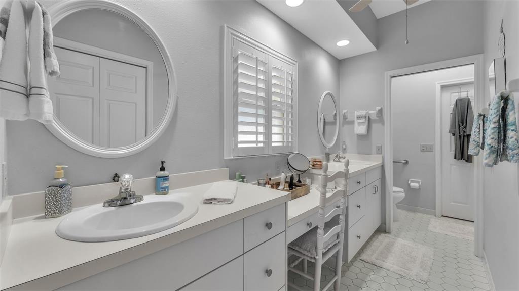 728 Canberra Road Winter Haven, FL 33884 - Photo 28 of 47 a bathroom with a double vanity sink mirror and bathtub