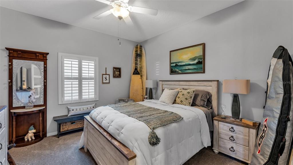 728 Canberra Road Winter Haven, FL 33884 - Photo 33 of 47 a bedroom with a bed and a flat tv screen on dresser