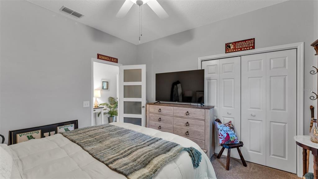 728 Canberra Road Winter Haven, FL 33884 - Photo 34 of 47 a bedroom with a bed and a flat screen tv
