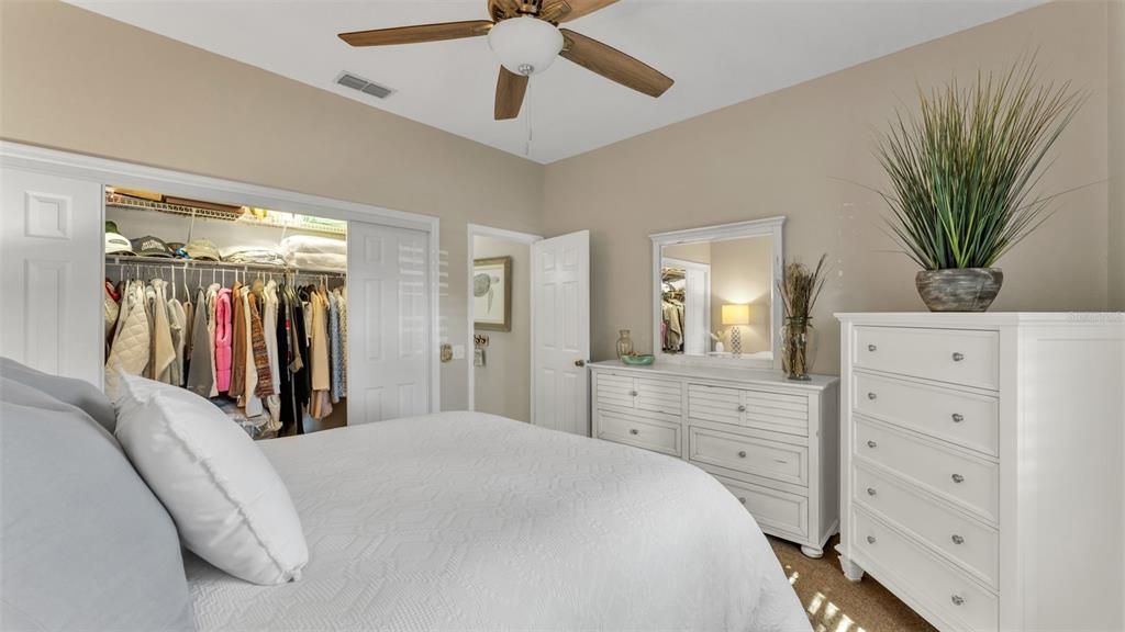 728 Canberra Road Winter Haven, FL 33884 - Photo 37 of 47 a bedroom with a large bed and a chandelier