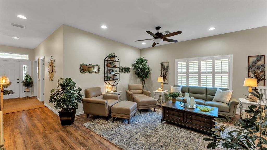 728 Canberra Road Winter Haven, FL 33884 - Photo 6 of 47 a living room with furniture or couch and a flat screen tv