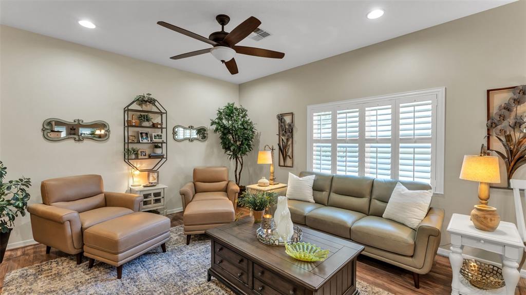 728 Canberra Road Winter Haven, FL 33884 - Photo 8 of 47 a living room with furniture ceiling fan and a large window