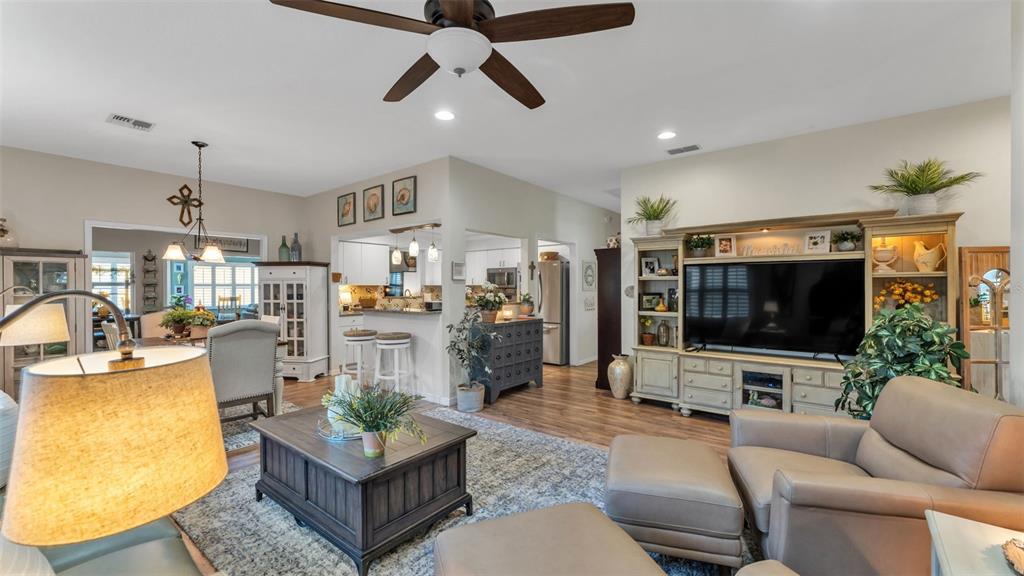 728 Canberra Road Winter Haven, FL 33884 - Photo 9 of 47 a living room with furniture and a flat screen tv
