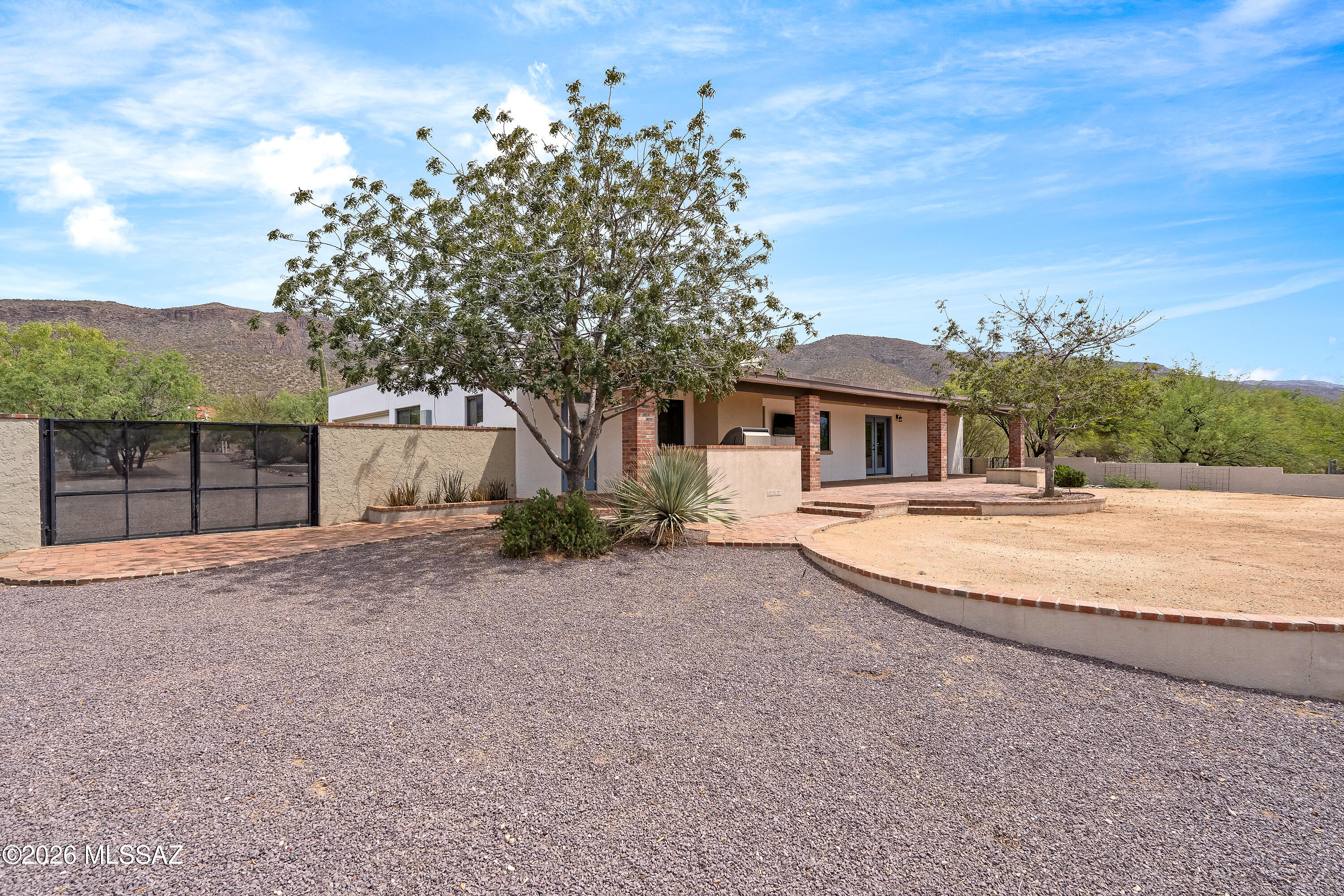 9420 East Ravine Trail Tucson, AZ 85749 - Photo 27 of 39 a front view of a house with a yard and garage