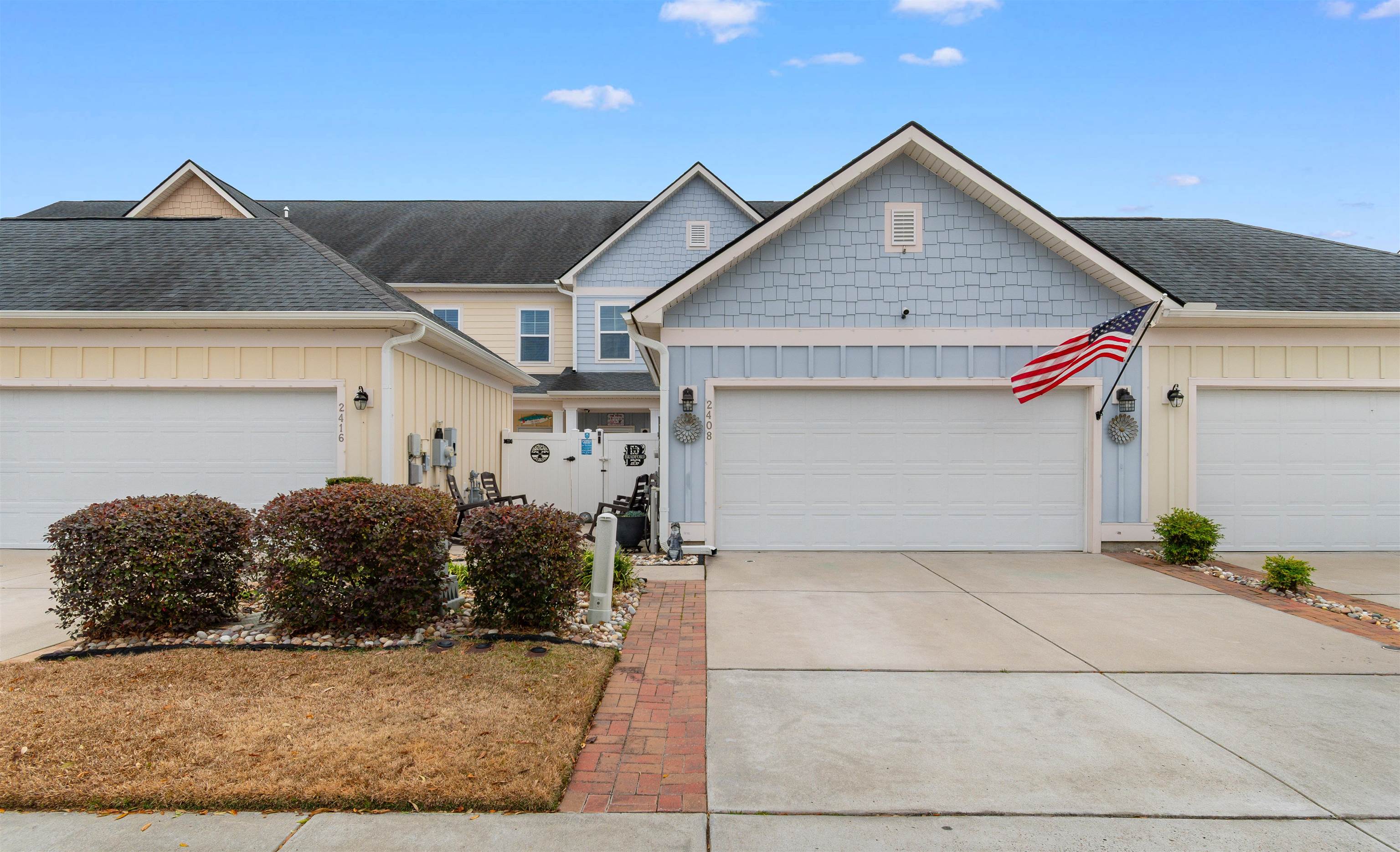 View of front facade with board and batten siding, an attached garage, concrete driveway, and a shingled roof