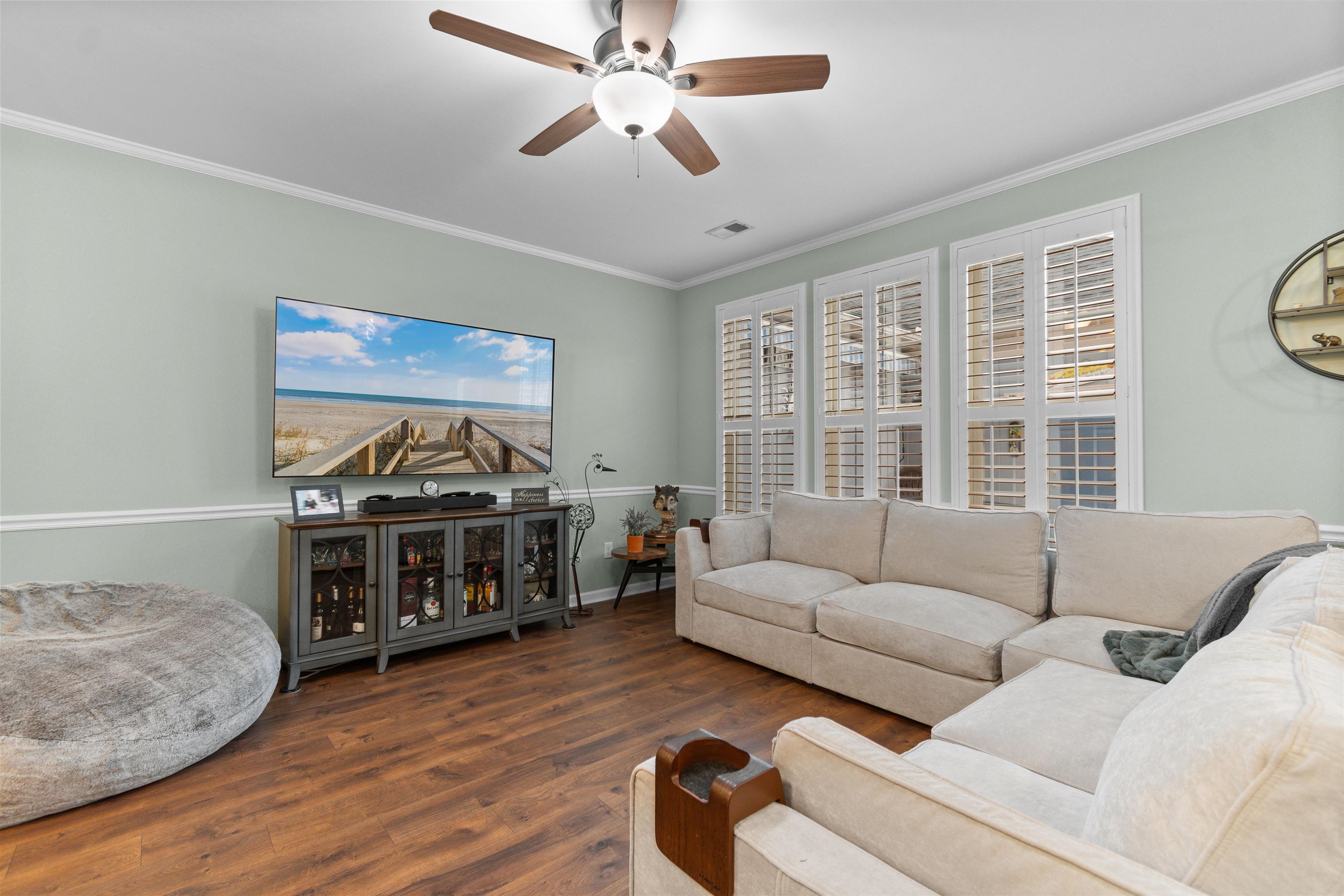 2408 Heritage Loop, Unit 2408 Myrtle Beach, SC 29577 - Photo 10 of 40 Living area featuring ornamental molding, ceiling fan, and wood finished floors
