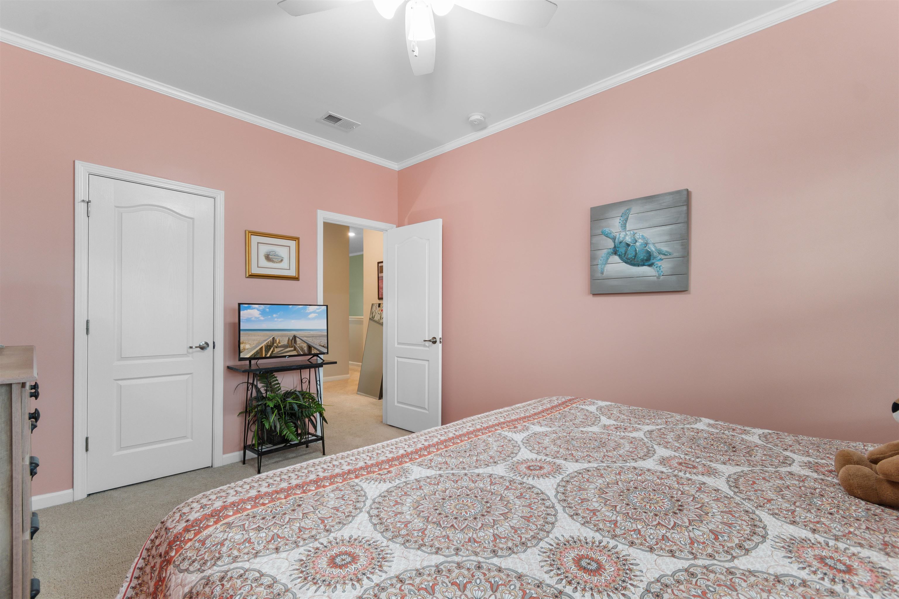 2408 Heritage Loop, Unit 2408 Myrtle Beach, SC 29577 - Photo 16 of 40 Bedroom with crown molding, light carpet, and ceiling fan